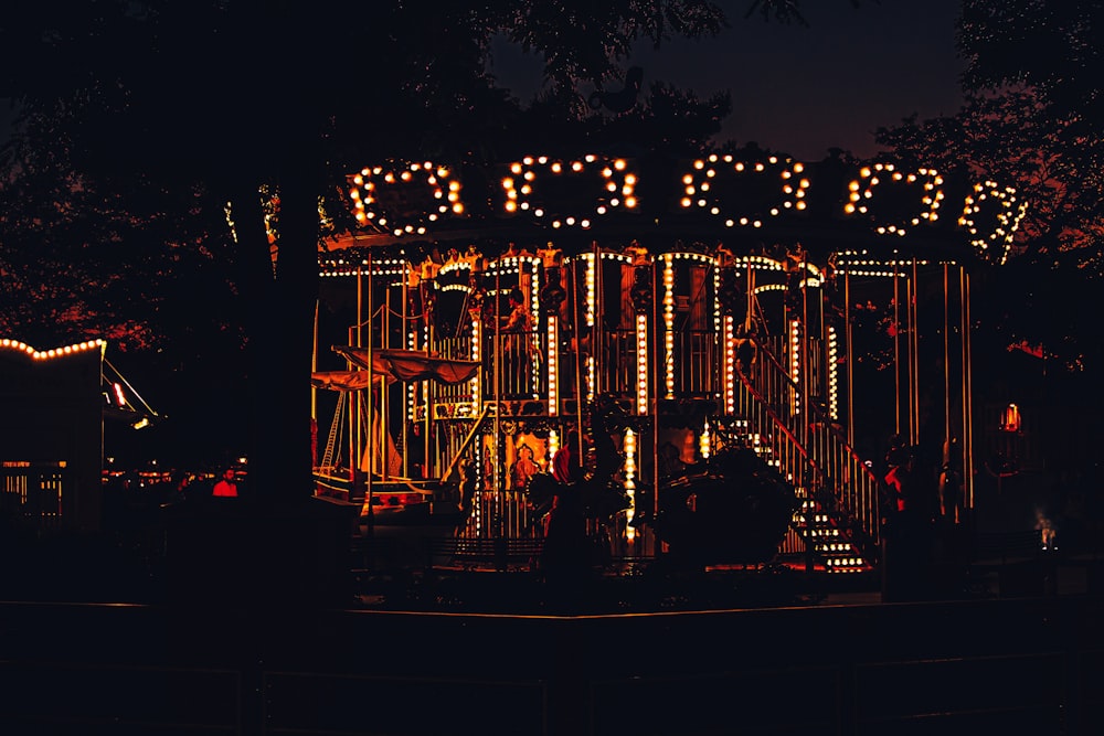 brown wooden bridge with lights during night time