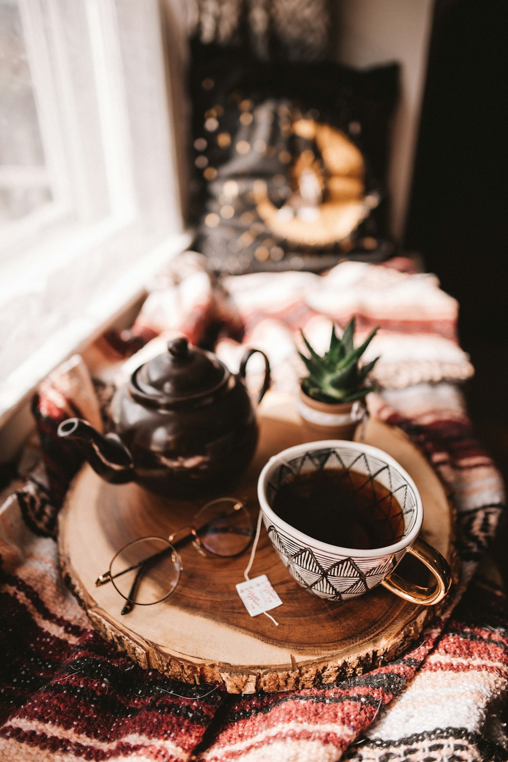black ceramic teapot on brown wooden tray