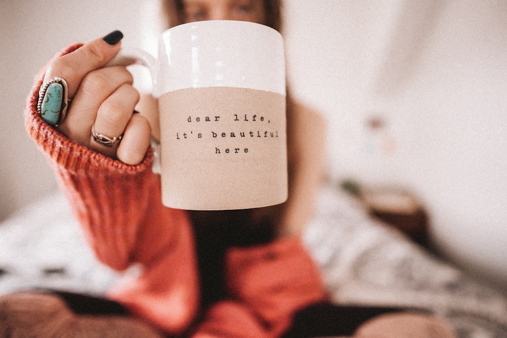 person holding white ceramic mug