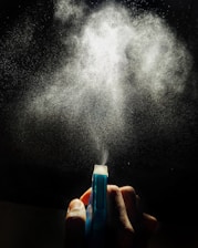 person holding blue and white plastic tube