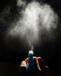 person holding blue and white plastic tube