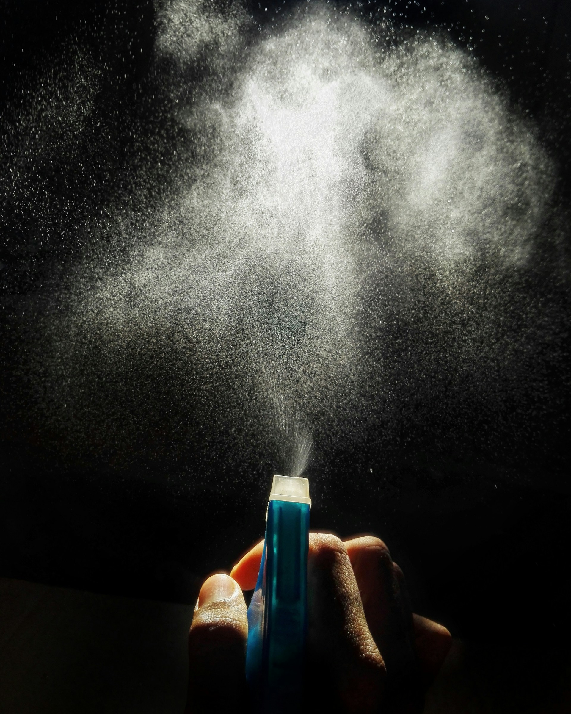 person holding blue and white plastic tube
