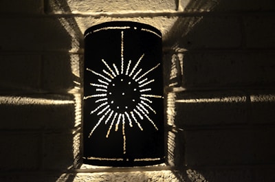 A beautifully designed wall sconce featuring intricate patterns.