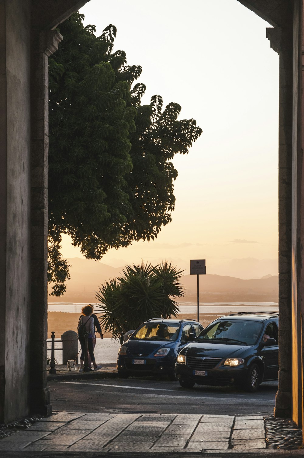 black sedan parked beside black car during daytime