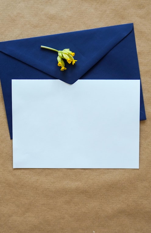 white and blue paper on brown textile