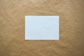 white paper on brown surface