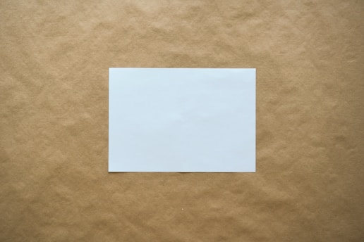 white paper on brown surface