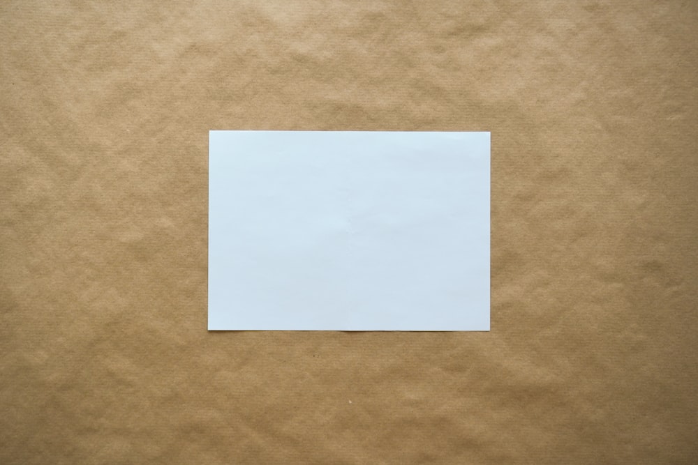 white paper on brown surface