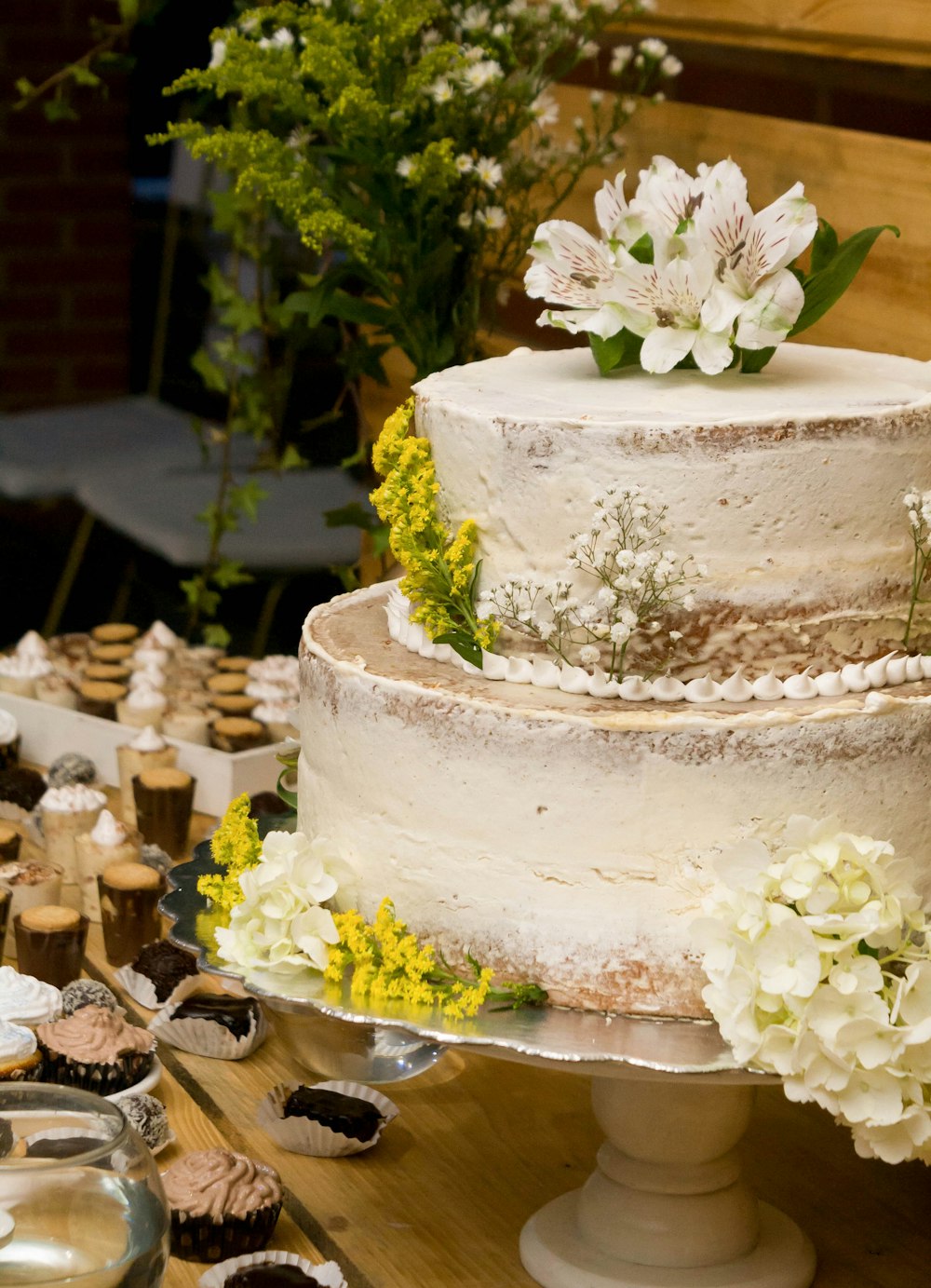 white 3 tier cake with white flowers