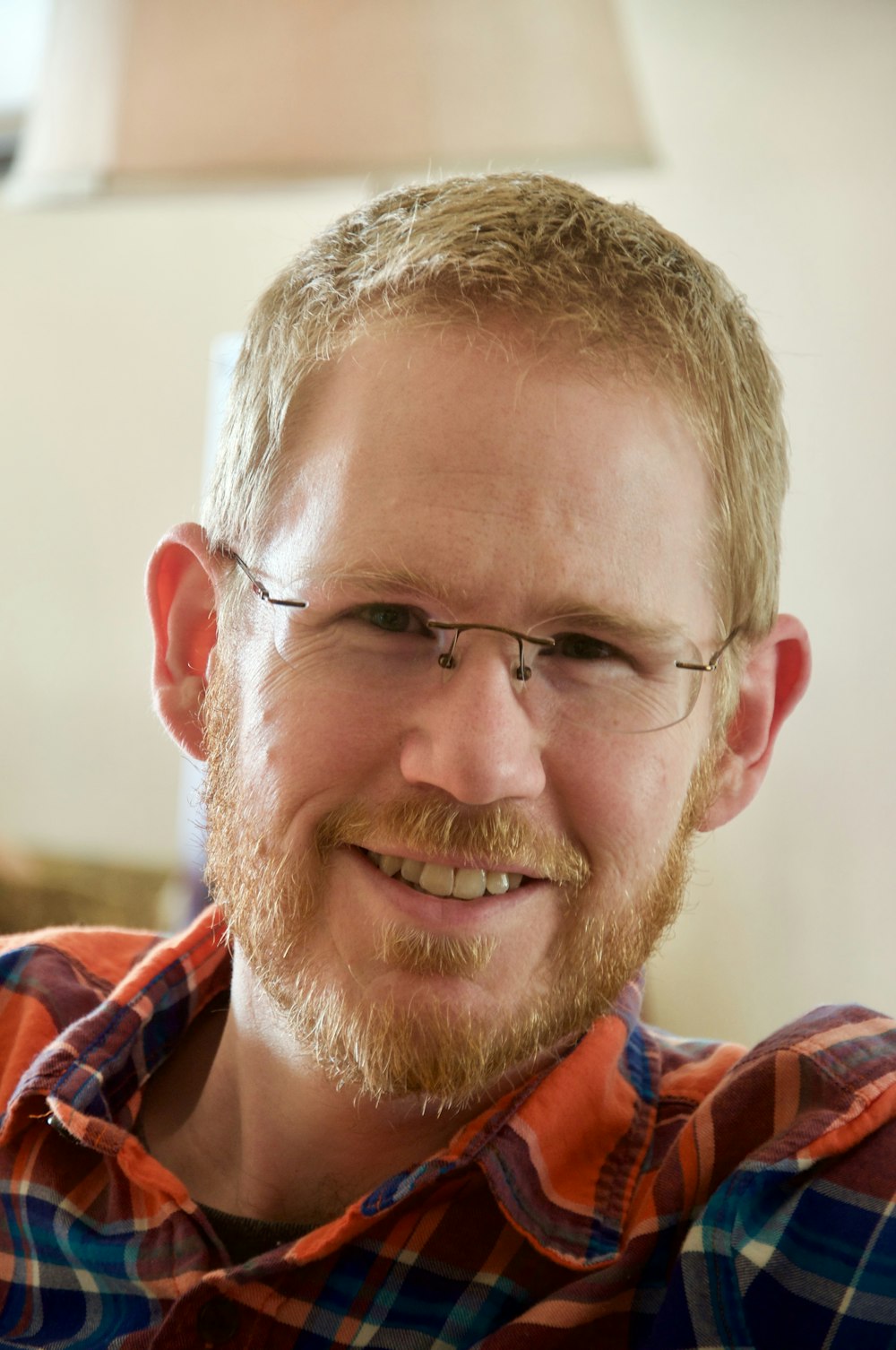 man in red blue and white plaid shirt