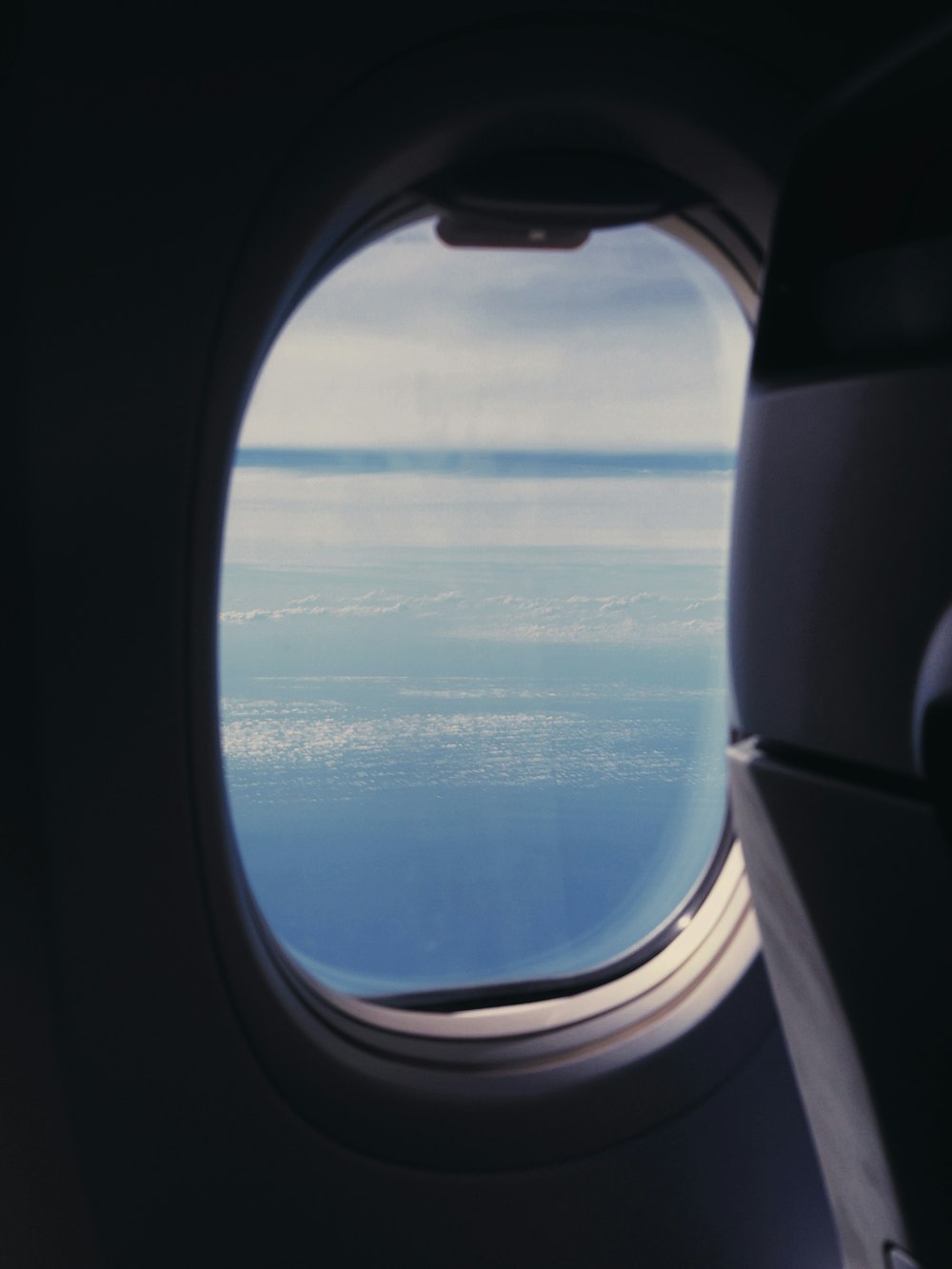 airplane window view of clouds during daytime