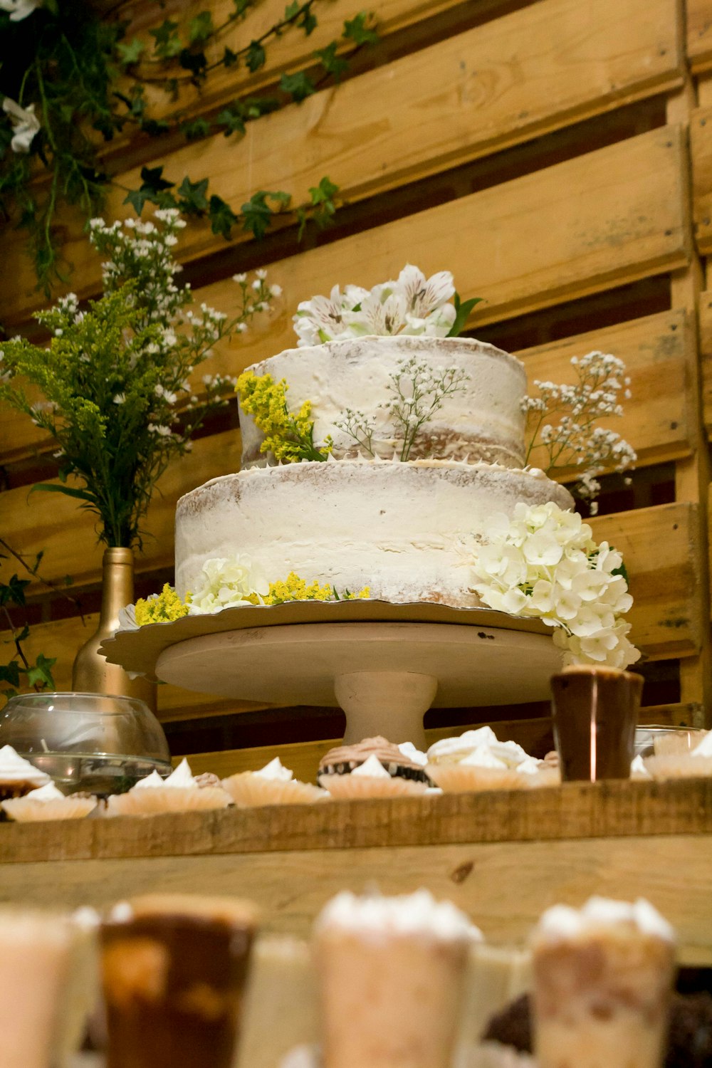 white 3 tier cake on brown wooden table
