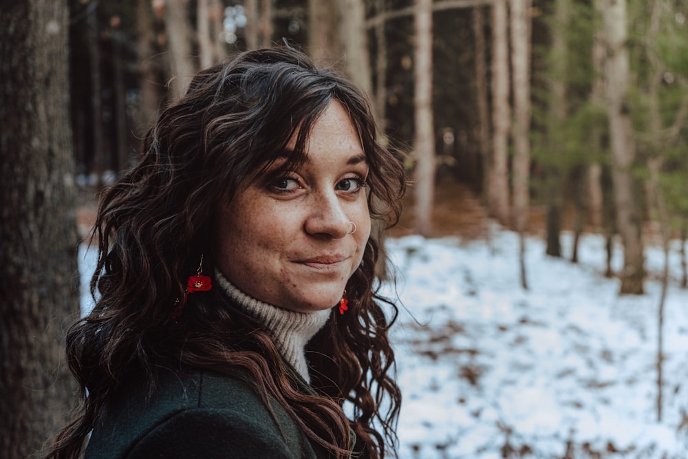 woman in green jacket with brown and white scarf