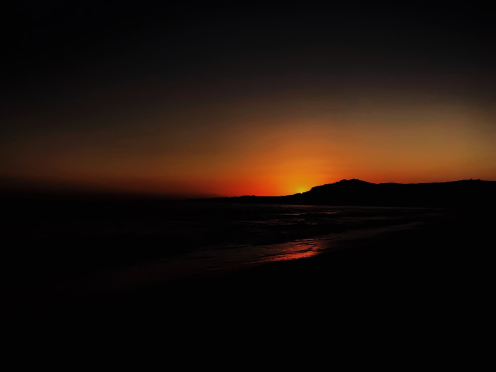 silhouette of mountain during sunset