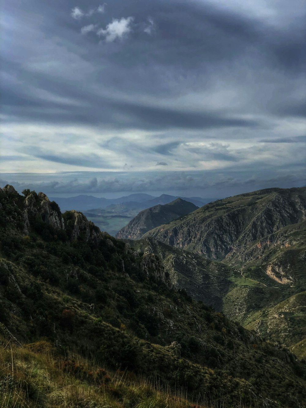 green mountains under white clouds during daytime