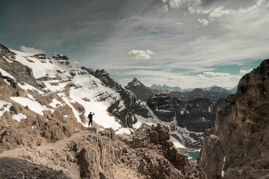 person standing on rock formation during daytime in Lake O'Hara Canada