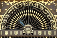 Finished steel gates with intricate designs showcased at the factory.