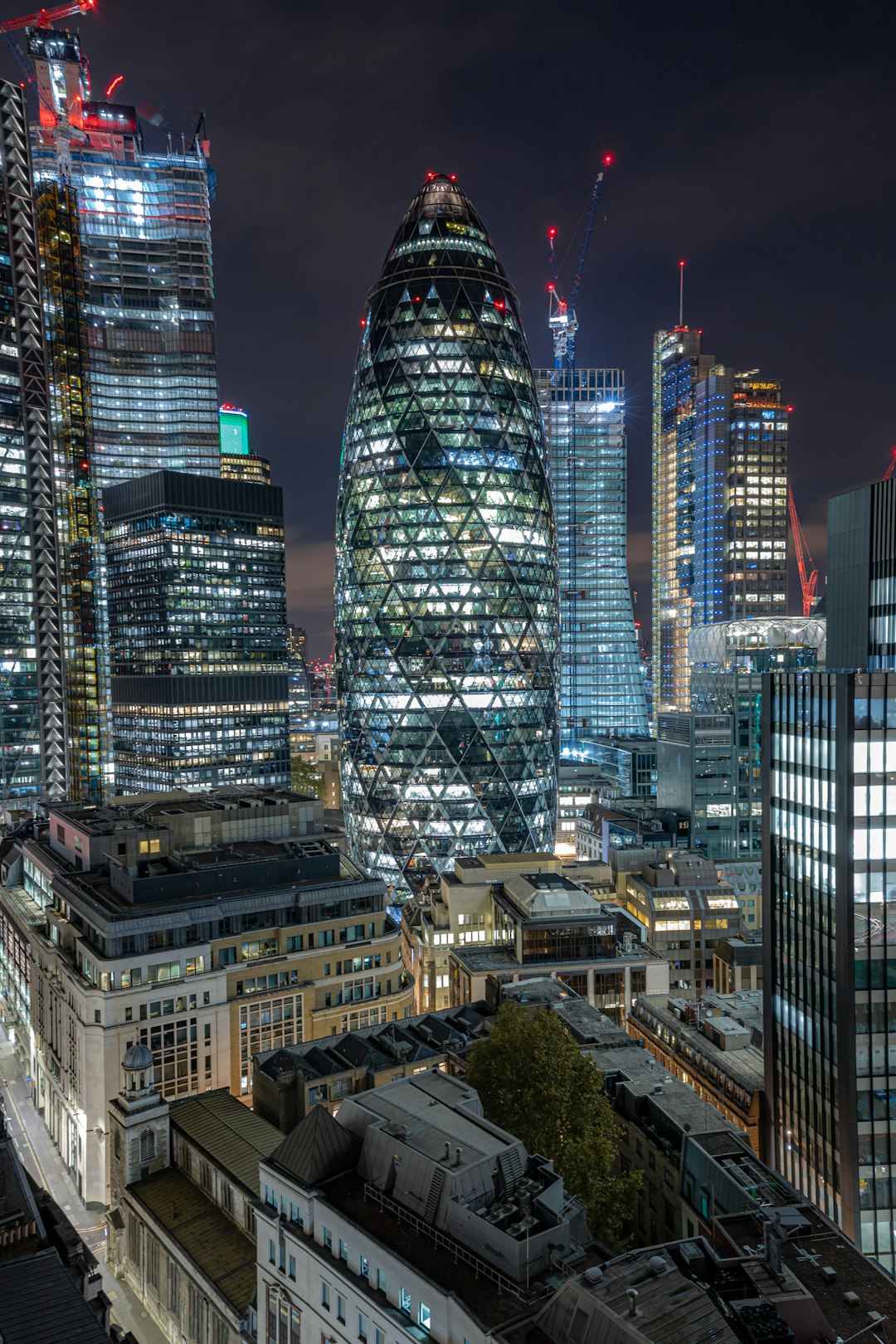 city buildings with lights turned on during night time