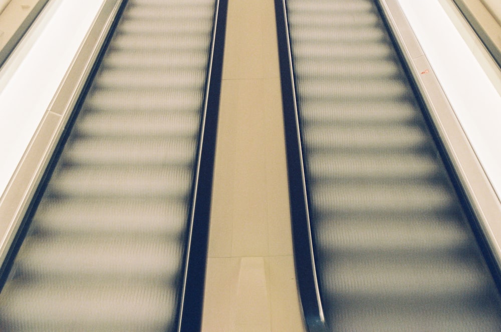 white and blue escalator in a room