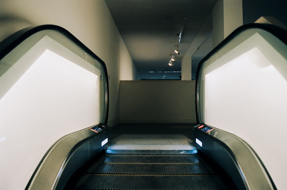 black and white escalator inside white room