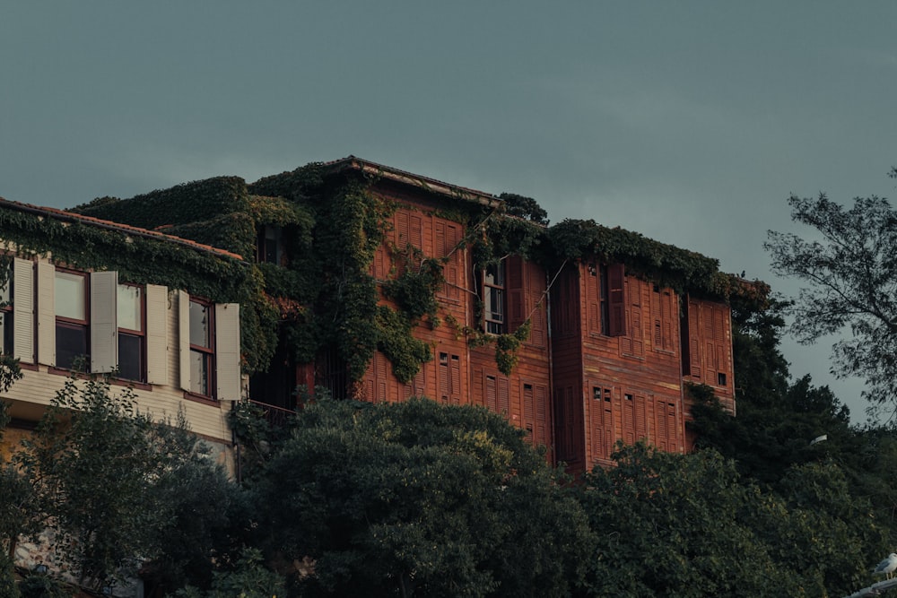 brown concrete building surrounded by green trees during daytime