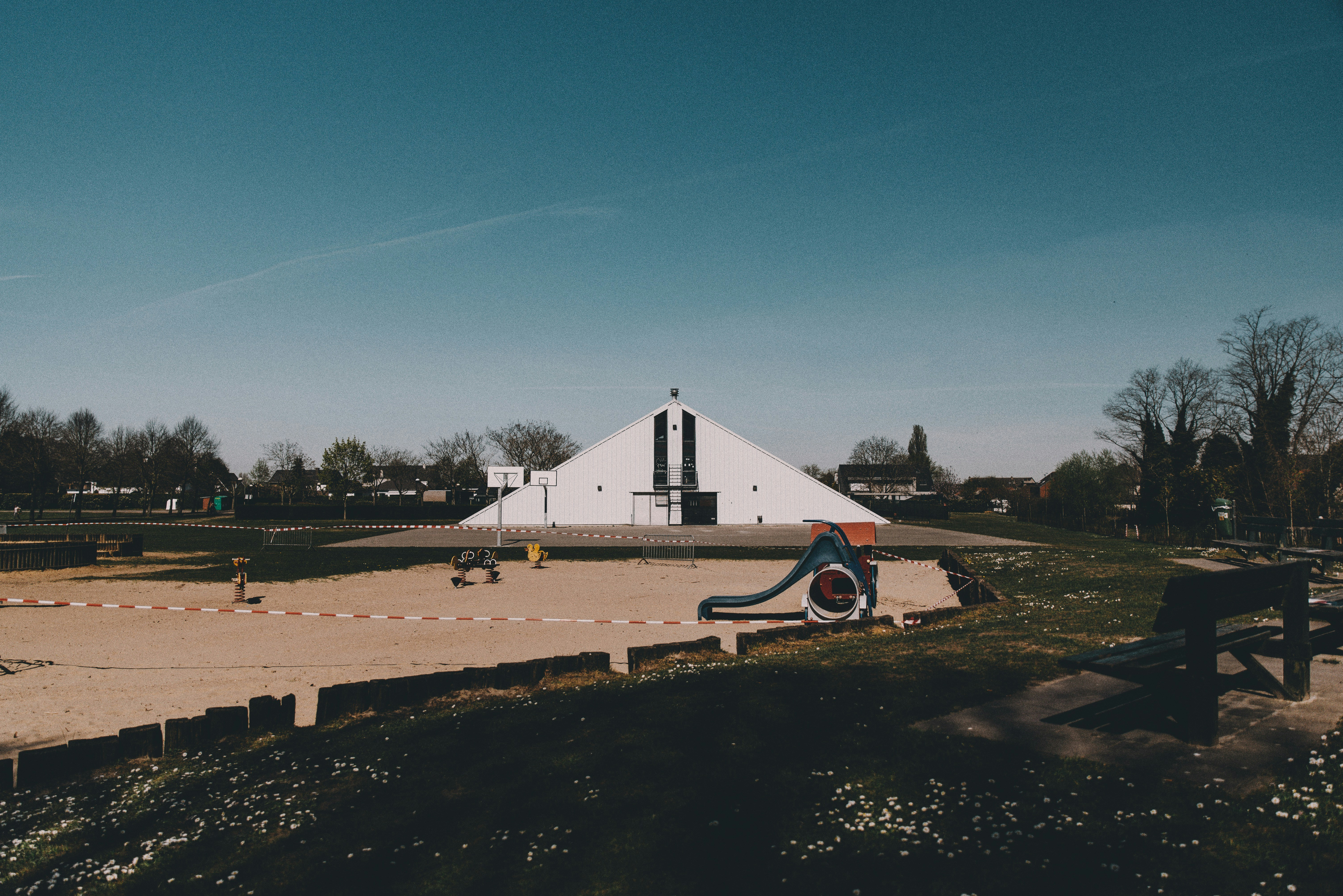 red car parked near white building during daytime