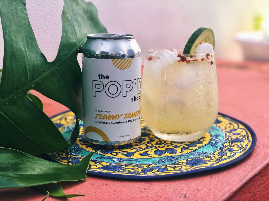 clear glass jar with white liquid inside, Relax with a refreshingly spicy cocktail topped with a cool cucumber treat.