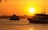 white and black boat on sea during sunset