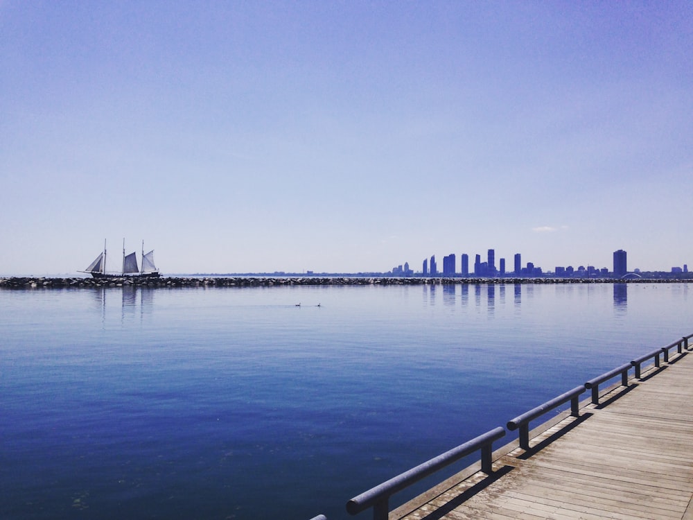 brown wooden dock on body of water during daytime