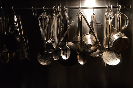 Image showing a selection of modern kitchen utensils and cookware arranged on shelves.