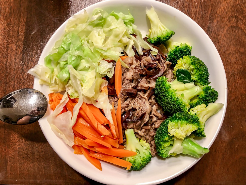 vegetable salad on white ceramic bowl