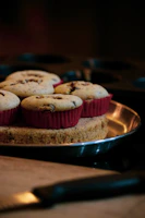 Stack of chocolate chip muffins with buttery crumb topping on a linen cloth.