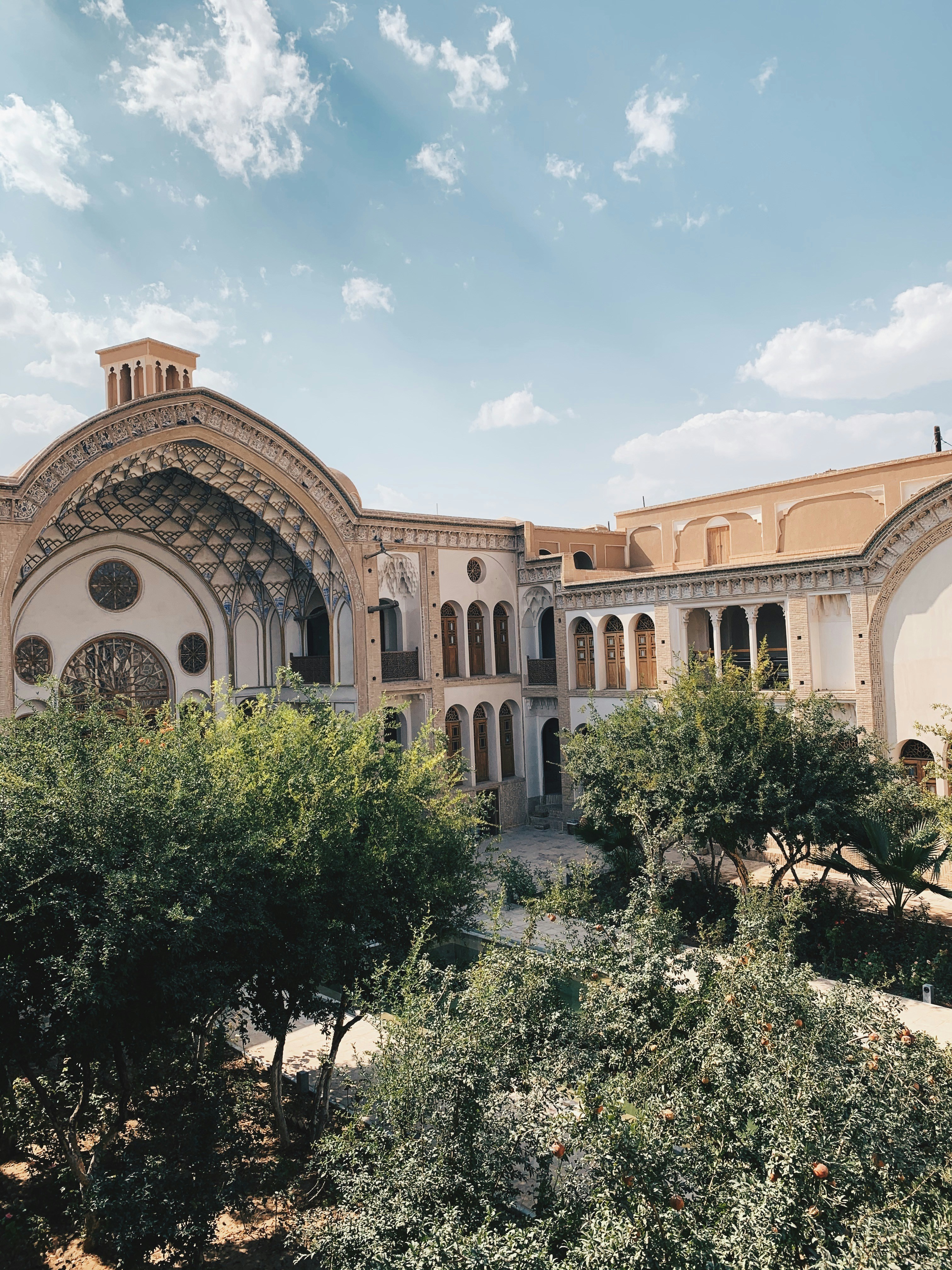 brown and white concrete building under blue sky during daytime
