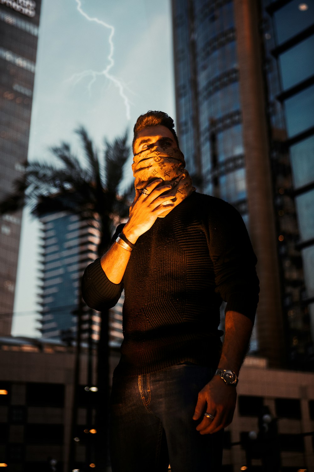 man in brown long sleeve shirt covering his face with his hand