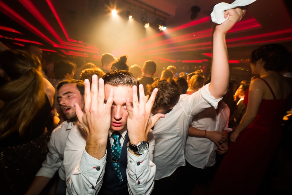 people raising their hands during night time