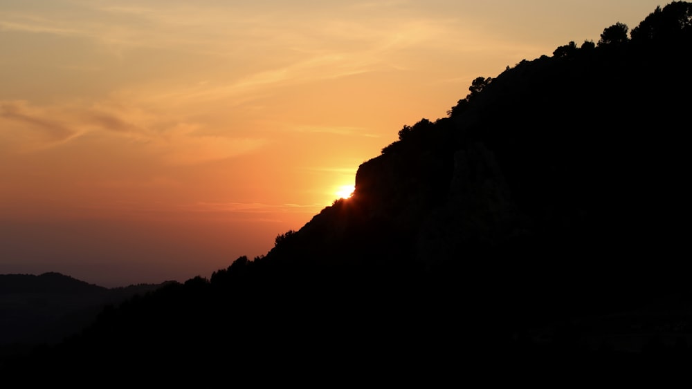 silhouette of mountain during sunset