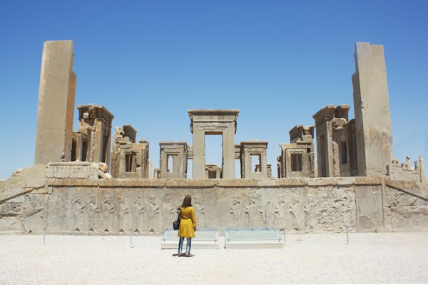 A visitor among the ruins of Persepolis, an hour from the city — Shiraz, Iran