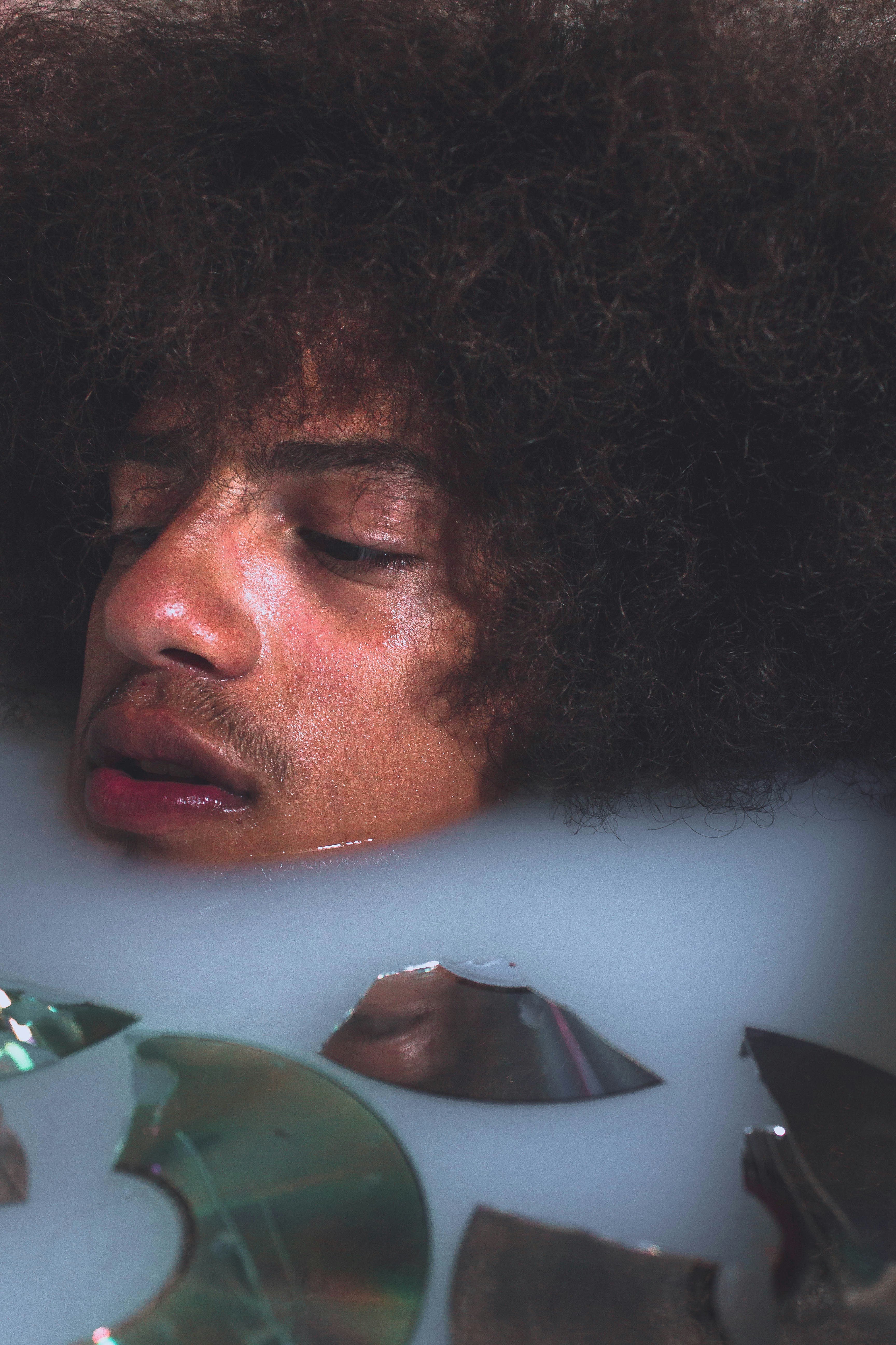 man in green shirt with curly hair