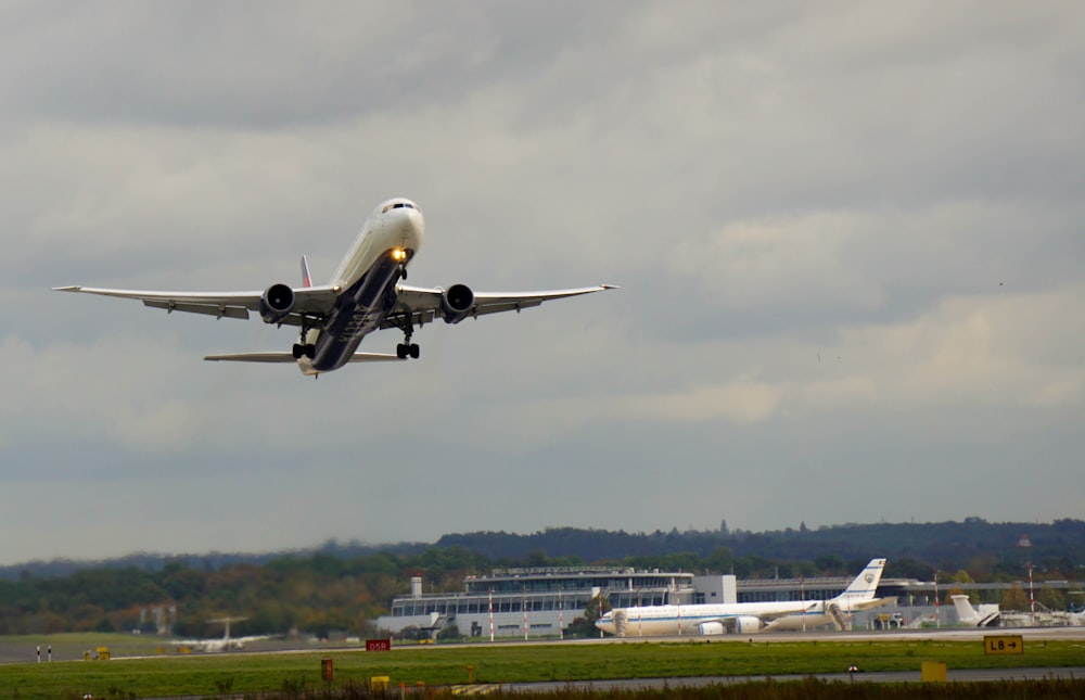 white airplane on airport during daytime