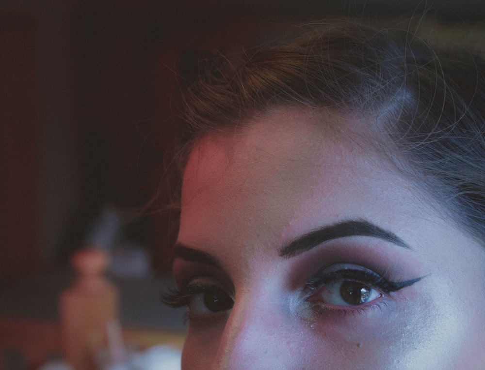 woman with brown hair and black eye shadow