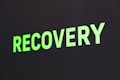 The word 'RECOVERY' is written in bright green capital letters against a dark background.