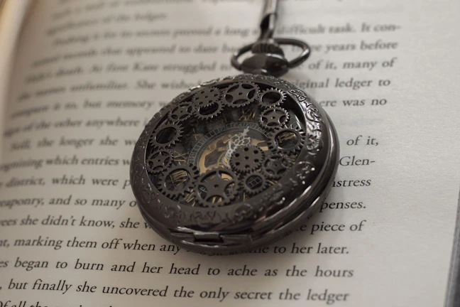 Close-up of an intricately designed antique pocket watch resting on aged parchment.
