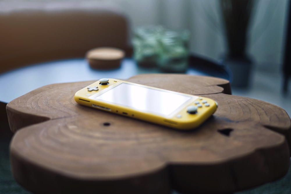 yellow and silver iphone case on brown wooden table