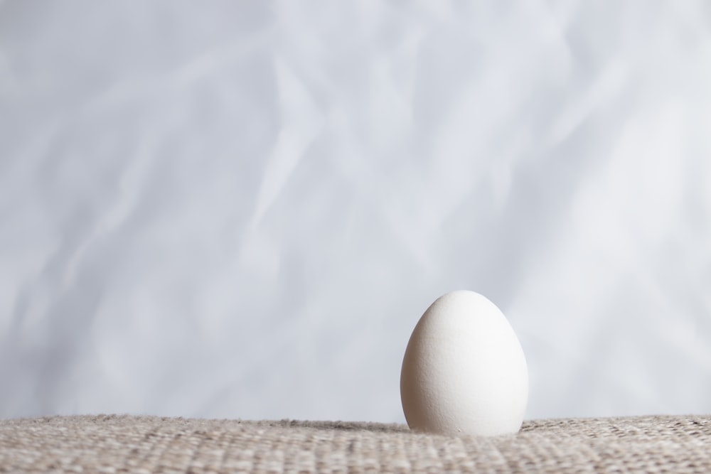 white egg on brown woven basket