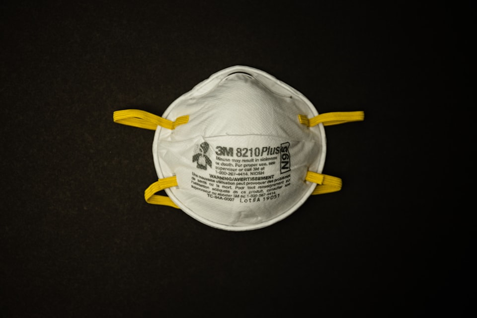 An N95 respirator on a black background