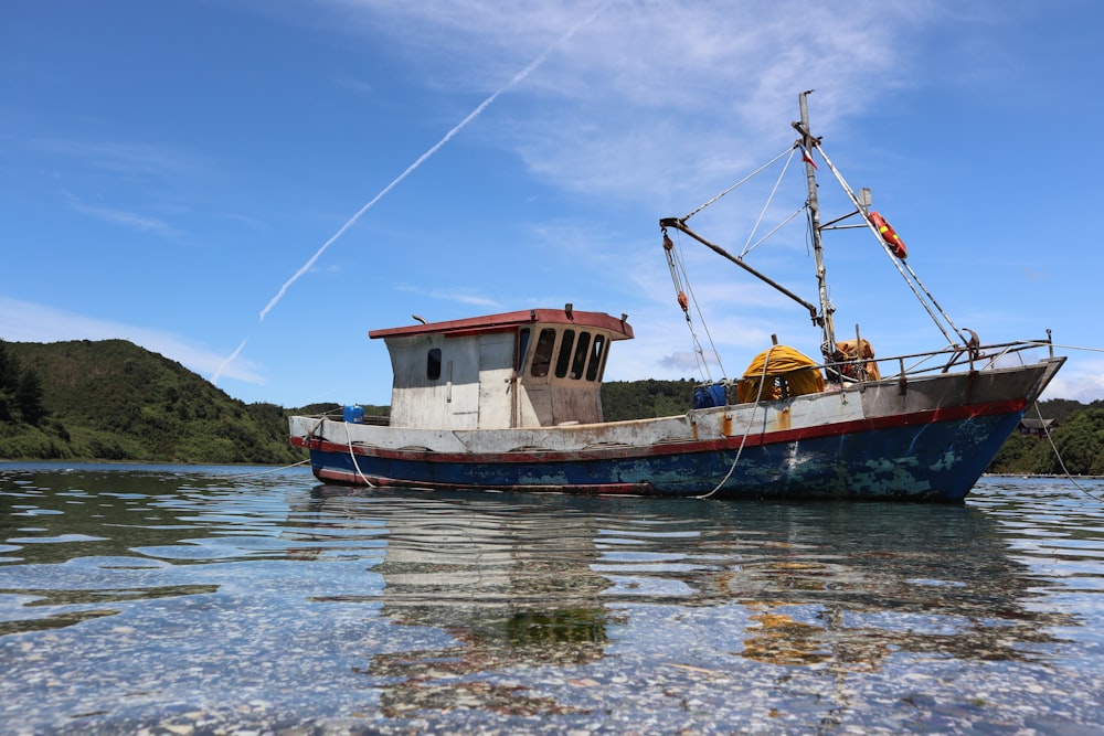 brown and white boat on water during daytime