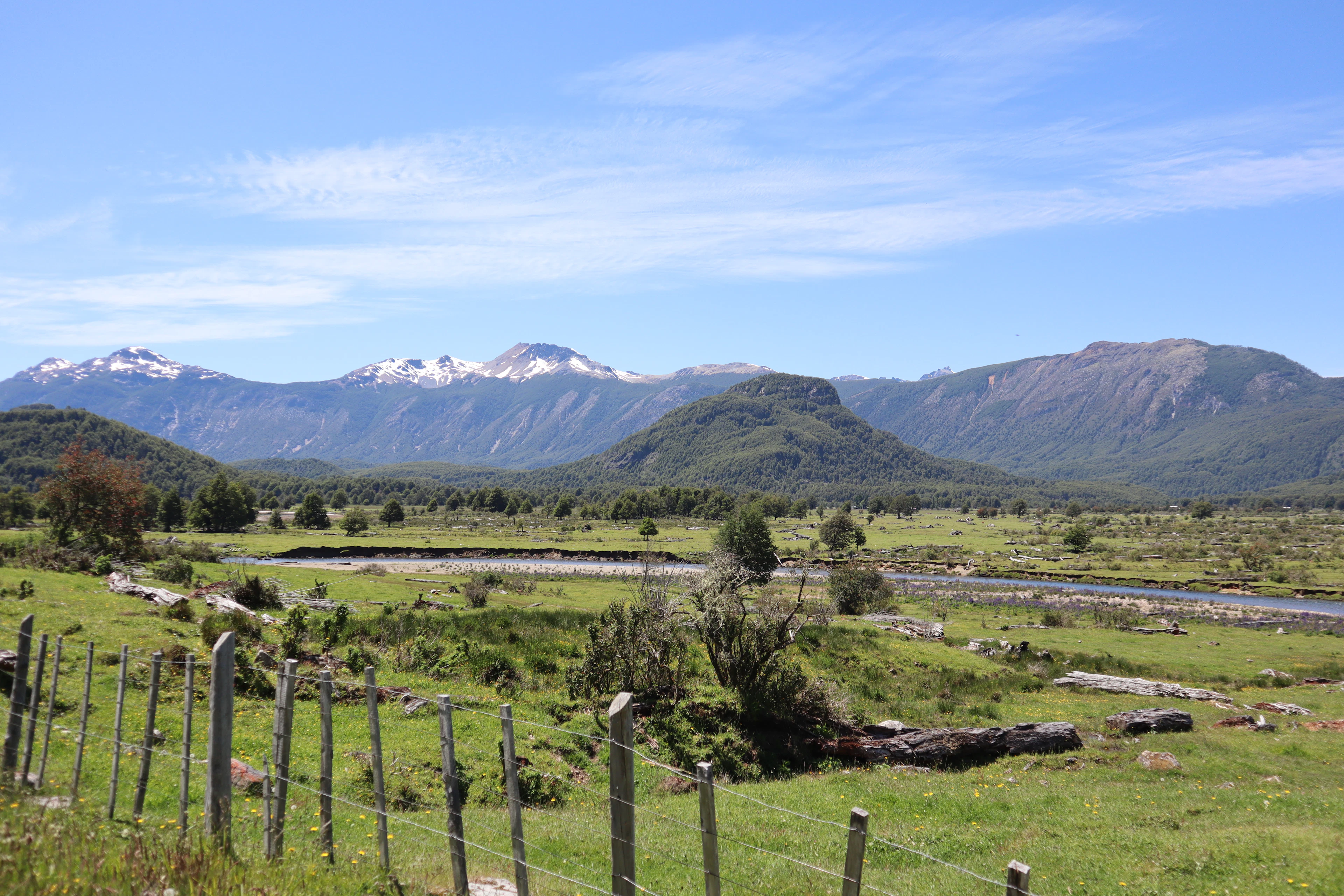 Green pastures, a river and snow-dusted peaks near Coyhaique, in the Aysén region