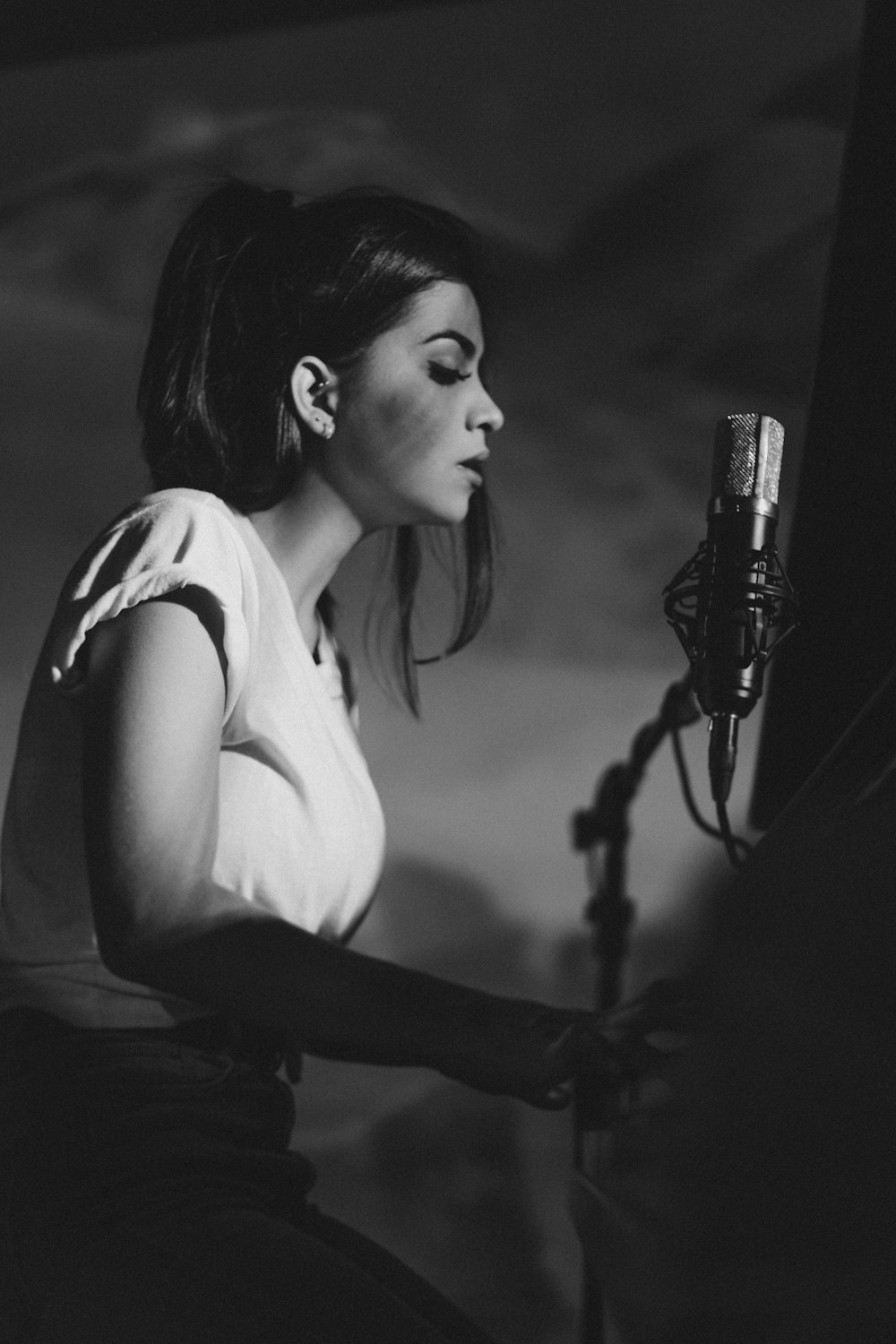 woman in tank top holding microphone