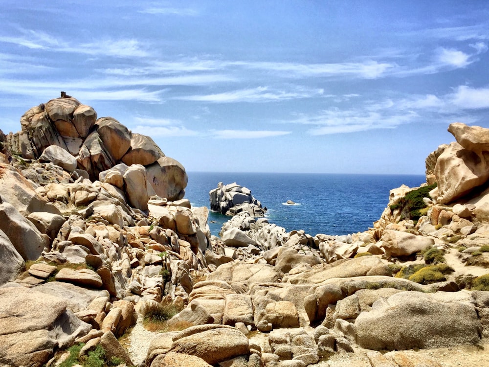 brown rocky shore under blue sky during daytime