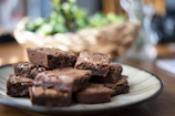 Close-up of rich homemade chocolate squares on a rustic wooden table.